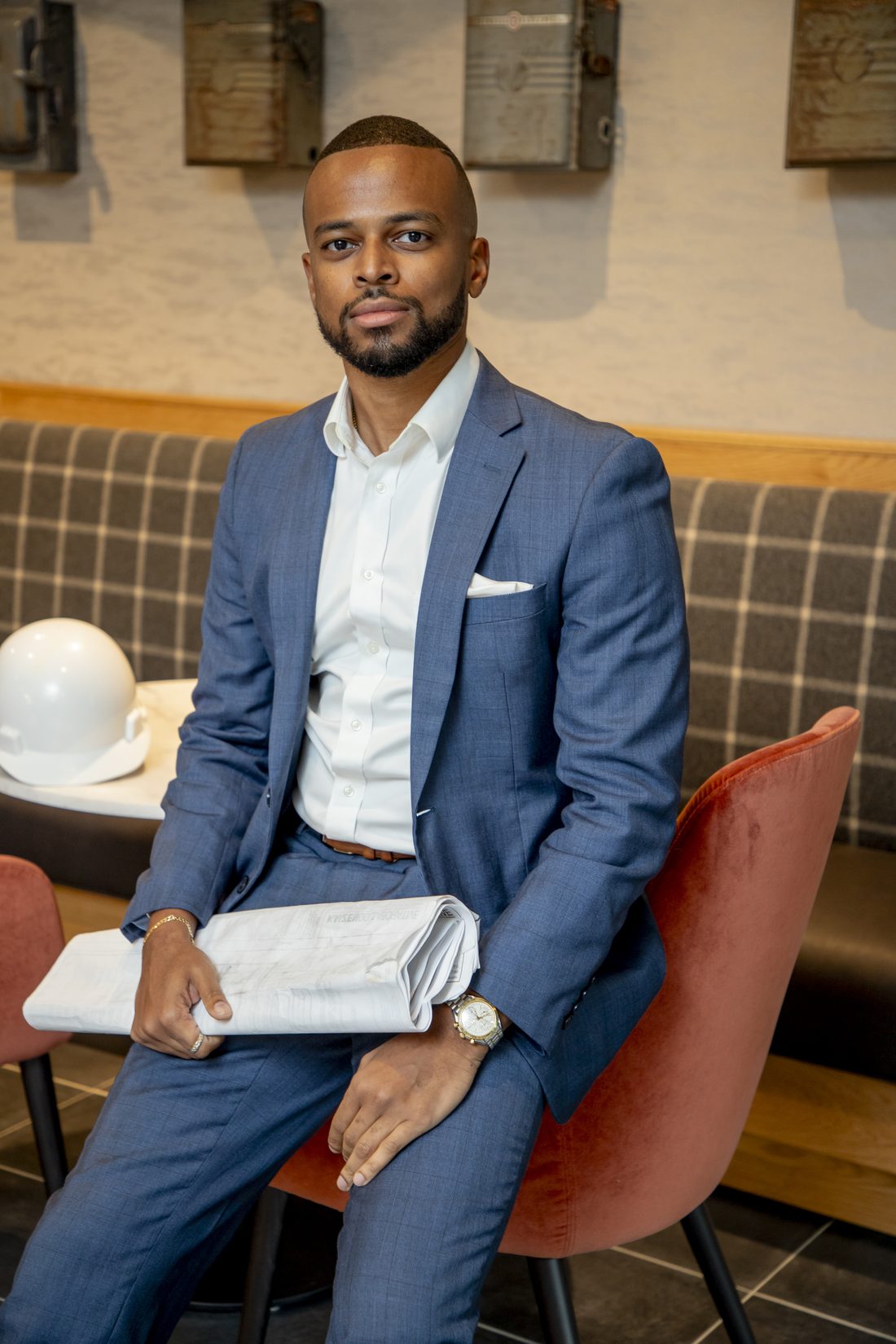 Chandler Chase, founder of One Signature Developments, holding construction plans